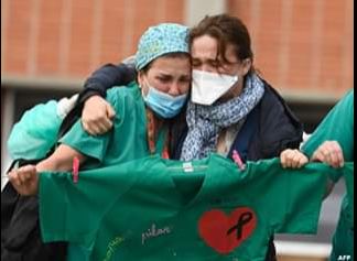 health-workers-console-wife-of-a-male-nurse-that-died-of-coronavirus-in-spain-esteban-Severo-Ochoa-Hospital-in-Leganes-near-Madrid-April-10-Spain-JPG